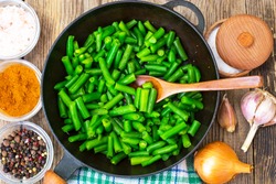 Green Beans on cast-iron frying pan. Studio Photo
