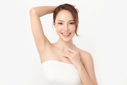 Beautiful Young Asian woman lifting hands up to show off clean and hygienic armpits or underarms on white background, Smooth armpit cleanliness and protection concept.