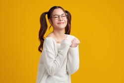 Beautiful young asian women feel happiness with positive expression, joyful on Yellow background. Happy adorable glad woman rejoices success. Facial expression.