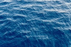 Sea surface. Blue water texture. Close up blue water surface at deep ocean