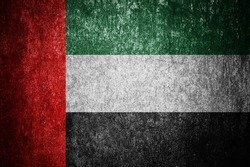 Closeup of grunge United Arab Emirates flag. Dirty United Arab Emirates flag on a metal surface.