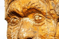 Sculpture made of wood is showing up a Canadian native old person made in wood traditional sculpture made by hand handcraft made with wood sculpture of the face of an old man yellow wood