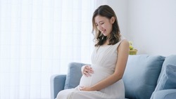 Young pregnant woman relaxing in the room