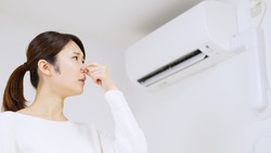 Air conditioner and Asian woman