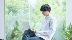 Asian young man working with a computer