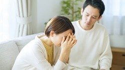 Asian couple depressed at home