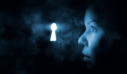 the woman's face in the dark looks through the keyhole glowing blue mysterious light