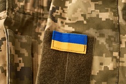 Ukraine flag and military uniform of ukrainian soldier. Armed Forces of Ukraine