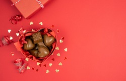 Box of chocolates on a red background. Copy space, Valentine's Day, Mother's Day, anniversary, birthday.