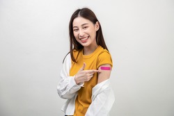 Portrait photo young attractive beautiful asian woman showing bandage happily after receive covid-19 antivirus vaccination safe life protect virus infection people healthcare social issue concept.	