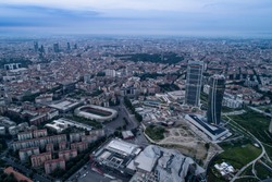 Aerial view of Milan (Italy) at dawn. On the right the new two skyscrapers of the CityLife district and the building site of the third tower.