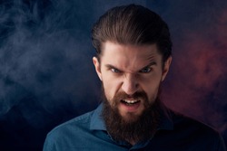 angry man with beard smoke colored background                               