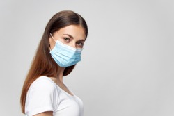 woman wearing medical mask looking ahead brunette isolated background 