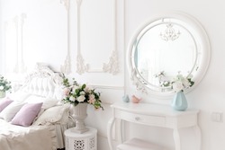 Boudoir table. Details of interior bedroom for girls and make-up, hairstyles with mirror