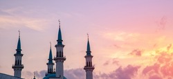 Banner Beautiful white islamic mosque with blue roof sunset cloud with sun light.