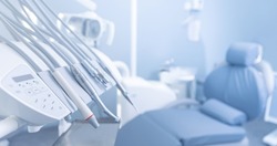 Banner dentists room office. Closeup different dental instruments and tools, blue toning.