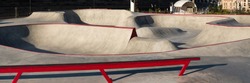 Skate park with concrete bowl, rail and pump track