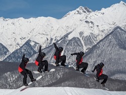 Burst shooting mode of snowboarder jumping grab trick at snowy mountains background in snowpark