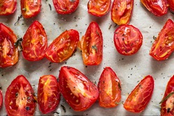 Sun dried tomatoes on white baking paper view from above