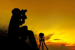 Silhouette photographer on mountain,Photographer shooting sunset,Beauty sunset,Shooting photographer with sunset public landmark
