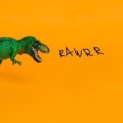 green dinosaur with open mouth and inscription rawrr on bright orange background