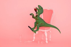 creative minimal poster with drunk dinosaur holding glass of wine on a pink background and sitting on a pink chair 