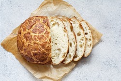 Fresh crispy Tiger (Dutch) bread with a delicious beautiful crust and wonderful homemade taste on a light background. Bakery product with cracks.