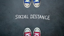 Social distance. two people keep spaced between each other for social distancing, increasing the physical space between people to avoid spreading illness during transmission of COVID-19 outbreak