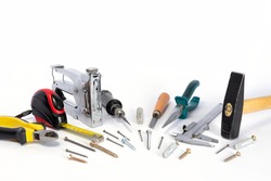 Tools and parts are on a white background. Metal object. A group of repair tools. Various parts and spare parts on the table. Tools for men. A set of working tools.