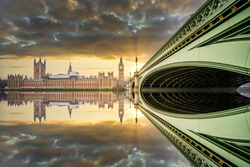 Big Ben and Westminster bridge at sunset with reflection in London. England