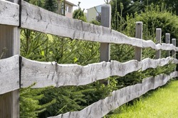Garden fence made of old boards as a privacy screen and demarcation - picket fence