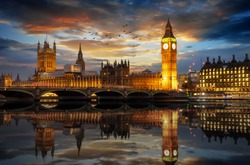 The Westminster Palace and the Big Ben clocktower by the Thames river in London, United Kingdom, just after sunset