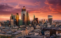 Fiery sunset over the urban skyline of the financial district City of London, United Kingdom
