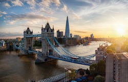 Aerial panoramic view to the iconic Tower Bridge and skyline of London, UK, during sunset time