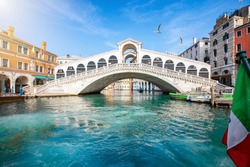 Beautiful view from the Canal Grande to the famous Rialto Bridge in Venice, Italy, without people and clear, emerald water
