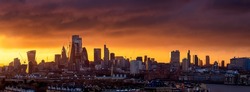 Wide panorama of the urban London City skyline during a colorful winter sunset, England