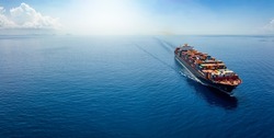 Aerial panorama of a cargo ship carrying container for import and export, business logistic and transportation in open sea with copy space 