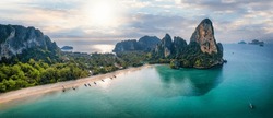 Panoramic aerial view of the beautiful Railay beach, Krabi, Thailand, lush rain forest and emerald sea during morning sunrise without people