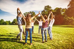 Group of Friends Making a Circle and Holding Hands Together