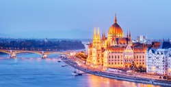 Budapest skyline, Hungary - illuminated Hungarian Parliament in twilight. Spectacular Panoramic view on Danube river delta and bridge. Famous European travel destination. 