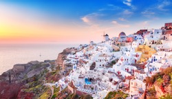 Charming sunset view of traditional Greek village Oia on Santorini island in Greece. Santorini is iconic travel destination in Greece, famous of its sunsets and traditional white and blue architecture