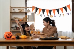 Happy family mother and child happy girl with holiday Halloween. Happy Halloween. Recipe pumpkin puree. Ingredients for pumpkin pie for Thanksgiving day