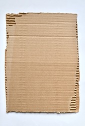 Ripped piece of cardboard. Kraft paper background