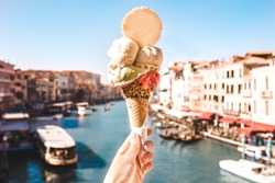 Delicious icecream in beautiful Venezia, Italy in front of a canal and historic buildings
