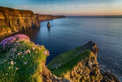 Ireland countryside tourist attraction in County Clare. The Cliffs of Moher and castle Ireland. Epic Irish Landscape Seascape along the wild atlantic way. Beautiful scenic nature hdr Ireland.