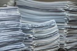 bundles bales of paper documents. stacks packs pile on the desk in the office. waste paper, paper trash
