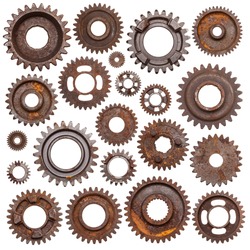 A huge set of rusty metal gears isolated on a white background.