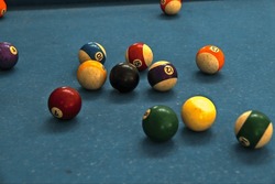 a collection of billiard balls on a billiard table.