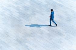 top aerial view businessman people walk on across pedestrian concrete with black silhouette shadow on ground, concept of social still life.