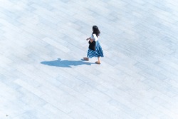 top aerial view woman people walk on across pedestrian concrete with black silhouette shadow on ground, concept of social still life.